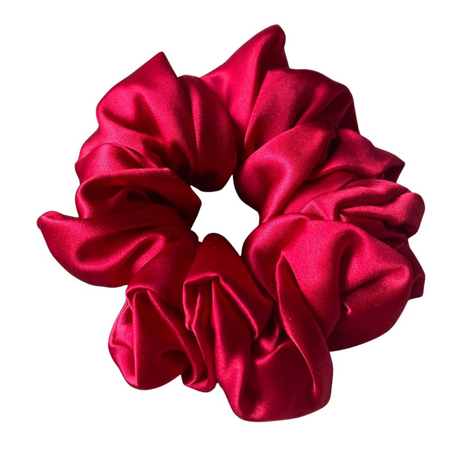 Red silk scrunchie on a white background