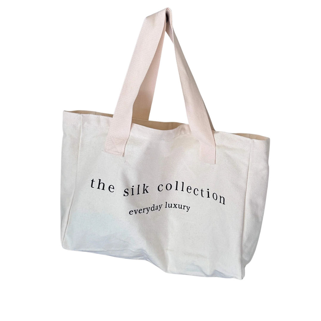 Large canvas tote bag with natural handles printed with The Silk Collection logo
