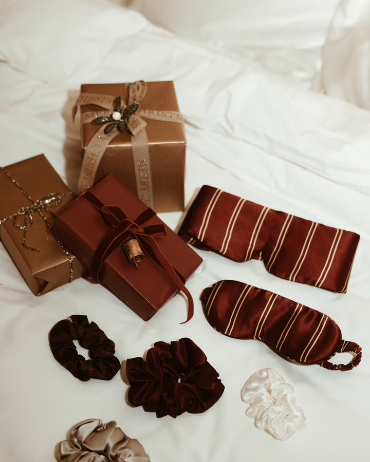 Christmas flat lay stripe silk eye masks scrunchies wrapped gifts