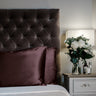 Espresso limited edition mulberry silk pillowcases, 22 momme 100% silk, on a velvet headboard | The Silk Collection
