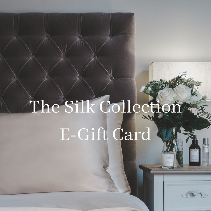 The Silk Collection digital e-gift card shown over a silk pillowcase on a velvet headboard